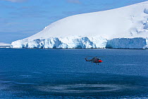 Royal Navy helicopter from HMS Endurance hovering over sea off Antarctica, November 2008,  Taken on location for the BBC series, Frozen Planet.