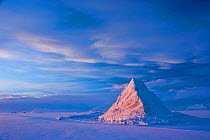 Pyramid of sea ice catching the first rays of the returning sun in the high Arctic, Svalbard, Spitsbergen, Norway, February 2009. Taken on location for the BBC series, Frozen Planet.