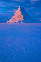 Pyramid of sea ice catching the first rays of the returning sun in the high Arctic, Svalbard, Spitsbergen, Norway, February 2009. Taken on location for the BBC series, Frozen Planet.