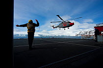 Naval helicopter landing on deck of Royal Navy ship, HMS Endurance, Antarctica, November 2008. Taken on location for the BBC series, Frozen Planet.