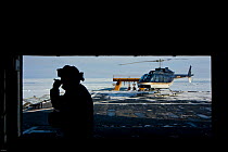 Helicopter and crew on deck of US Coastgaurd ship 'Healy' in frozen Bering Sea, Alaska, March 2008. Taken on location for the BBC series, Frozen Planet.