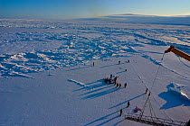 Aerial view of science teams and Frozen Planet film crew working on the sea ice in the Bering Sea, Alaska, USA, March 2008. The film crew were in search of Spectacled eider ducks, temperatures rarely...