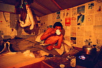 Inuit hunter drinking tea inside hut near Igloolik. Nunavut, Canada, 1990. 40 BELOW bookplate.