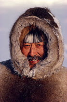 Inuit man dressed in Reindeer / Caribou skin clothes. Igloolik, Nunavut, Canada, 1990. 40 BELOW bookplate.
