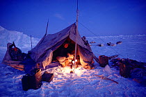 Inuit hunter lighting stoves to warm his tent, Northwest Greenland, 1986. 40 BELOW bookplate.