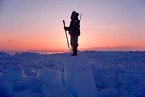 Inuit hunter Jens Danielsen scanning ice of Melville Bay for Polar bears. Northwest Greenland, 1986. 40 BELOW bookplate.