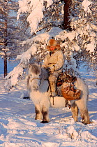 Hunter on Horse (Equus Caballus) at Korban in winter. Yakutia, Siberia, Russia, 1999. 40 BELOW bookplate.