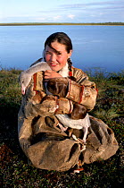 Nenets girl with pet Swan cygnet, probably Whistling swan (Cynus columbianus). Nadym Tundra, Yamal, Western Siberia, Russia, 2000.  40 BELOW bookplate.
