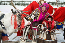 Nenets woman and daughter dressed up for spring Reindeer / Caribou (Rangifer tarandus) herders' festival. Yamal, Northwest Siberia, Russia, 2006. 40 BELOW bookplate.