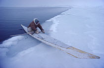 Inuit hunter using kayak at ice edge in winter. Northwest Greenland, 1980. 40 BELOW bookplate.
