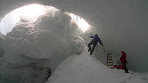 Entering the ice caves of Mount Erebus, Antarctica. Taken on location for BBC Frozen Planet series, 2009