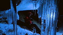 Filming around the extremely delicate ice formations in volcanic ice cave, Mount Erebus, Antarctica. Taken on location for BBC Frozen Planet series, 2009