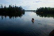Canoe on Little Saganaga Lake in the Boundary Waters Canoe Area Wilderness at dawn, Minnesota, USA, Model released