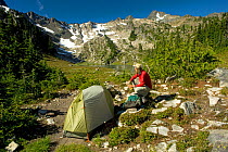 Hiker looking at the view from campsite at Lake of The Angels, Olympic National Park, Washington, USA, September 2010. Model released