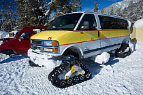 Van with wheels converted van for snow travel, Norris Geyser Basin, Yellowstone National Park, Wyoming, USA, February 2011