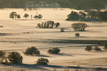View south over the Somerset Levels from Walton Hill on a misty winter evening with snow on the ground. View includes Butleigh Moor, Somerton Moor, Street Moor, Low Ham Moor, Walton Moor, Pitney Moor,...