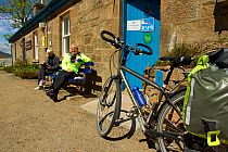 Visitors taking a break outside Forsinard Flows RSPB visitor centre, Flow Country, Sutherland, Scotland, UK, June 2011