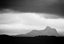 Silhouette of Stac Pollaidh against sotrm sky, viewed from Tanera More, Coigach and Assynt, Sutherland, Scotland, UK, July 2011
