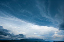 Cloud formations in sky above silhouette of Stac Pollaidh viewed from Tanera More, Coigach and Assynt, Sutherland, Scotland, UK, July 2011