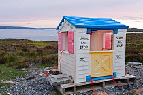 Plastic 'wendy house' serving as school bus stop, near Achiltibuie, Coigach and Assynt, Sutherland, Scotland, UK, June 2011