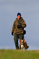 Man out birdwatching with his dog, RSPB Balranald nature reserve, North Uist, Western Isles / Outer Hebrides, Scotland, UK, May 2011
