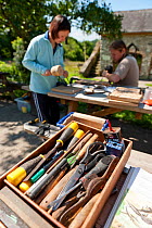 Wood working tools - Participants on wood-carving workshop at Denmark Farm Conservation Centre, Lampeter, Wales, UK. June 2011. Model released