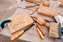 Tools on workbench at  wood-carving workshop,  Denmark Farm Conservation Centre, Lampeter, Wales, UK. June 2011. (Model released). Close-up of work and tools.