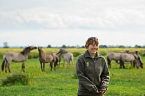 Konik horse (Equus caballus) Wicken Fen, Cambridgeshire, UK, June 2011. Volunteer Maddy Downes who looks after Wicken Fen's Konik horses and Highland cattle being interviewed for 2020VISION by Will Bo...