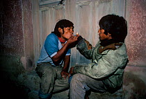 Child street addicts smoking crack cocaine. Cochabamba, Bolivia.
