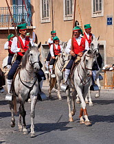 During the Festa do Colete Encarnado (Red Waistcoat Festival), a bull running festival, traditionally dressed cowboys, mounted on their horses, parade in the streets of Vila Franca de Xira, District o...