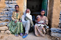 Family outside their home on the Grand Casso Pass, Ethiopian highlands, Rift Valley, Ethiopia, February 2009