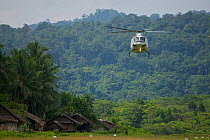 Helicopter arrives at Kwerba Village to airlift the expedition team into the Foja Mountains. Foja Mountains, Papua, Indonesia, 2008. (taken during Conservation International Rapid Assessment Program e...