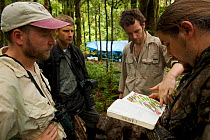 Foja Mountains RAP Expedition members confer on bird sightings at Bog Camp. Foja Mountains, Papua, Indonesia, 2008. (taken during Conservation International Rapid Assessment Program expedition)