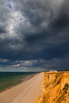 Coastguard cottages on cliff top, with storm clouds overhead, Weybourne, Norfolk, UK, July 2011