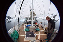 Dion Poncet, skipper, on board the 'Golden Fleece', Lemaire Channel, Antarctic peninsula, Antarctica, January 2009, taken on location for BBC Frozen Planet series