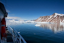 The Golden Fleece (base ship for BBC film crew) passing up the coast of the Antarctic Peninsula, Antarctica, January 2009, Taken on location for BBC Frozen Planet series