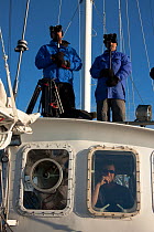 Dr Robert (Bob) Pitman and Dr John Durban, scientific advisors, watching for Killer whales (Orcinus orca) on board the 'Golden Fleece', off Antarctic Peninsula, Antarctica, January 2009, Taken on loca...