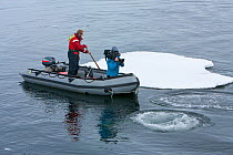 Filming Southern Type B Killer whales (Orcinus orca) in Antarctica. Taken on location for BBC Frozen Planet series, January 2009
