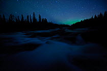 Northern lights far on the horizon in night landscape. Sarek National Park, Sweden, Europe, September.