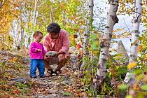 A man and his young daughter in an abandoned granite quarry on a trail on Millstone Hill, Barre, Vermont, USA. Model released, September 2010