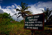 Sign warning that hunting turtles or collecting their eggs is illegal. Coast of Ghana, October 2010.