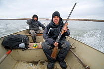 Young Inupiaq subsistence hunters head out on the Chukchi Sea to hunt Bearded seals, outside the arctic village of Point Lay, Alaska, USA, June 2011