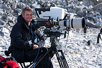 Wildlife Cameraman, John Aitchison, on location, filming Adelie penguins, Antarctica, February 2009, Taken on location for BBC Frozen Planet series