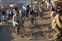 People on bicycles in rush hour through Nagpur, Maharashtra, India