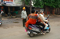 Indian family travelling on scooter together, Nagpur, Maharashtra, India