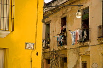 Building with people hanging out their washing, in Old Havana, UNESCO World Heritage Site, Cuba, Caribbean, 2011