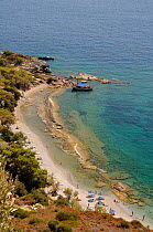 Tsopela beach and moored tour boat, Samos south coast, Greece, August 2011.