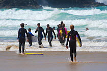 Young people enjoying the surf at Fistral Beach, Newquay, Cornwall, UK, July 2011.