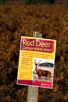 Sign informing public of the population of Red deer (Cervus elaphus) during the rutt, New Forest heathland, Hampshire, UK