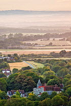 Michelham Priory viewed at dawn from Wilmington Hill, Wilmington, South Downs National Park, East Sussex, England, UK, July 2011